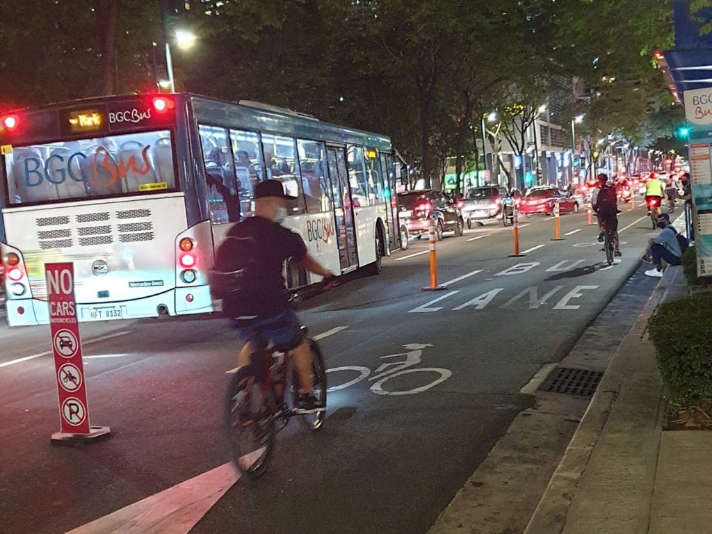 cyclists riding in a protected bike lane